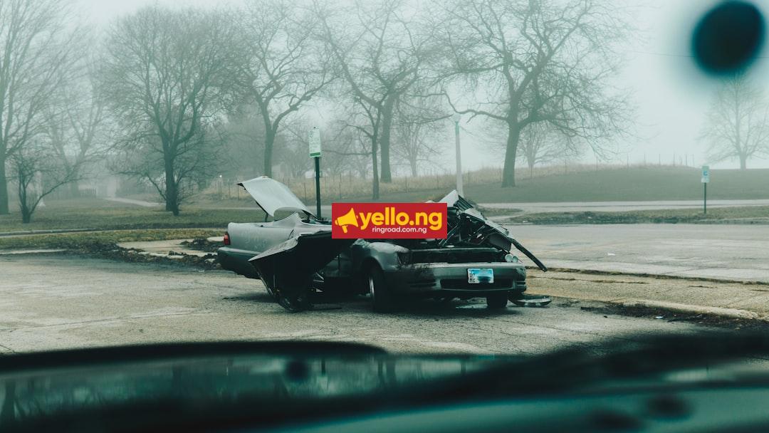 A wrecked car destroyed on a foggy roadside after a serious crash accident