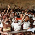 Nigerian secondary school students in Port Harcourt raise hands in a classroom, illustrating civic education and the Student Loan Act's target beneficiaries.