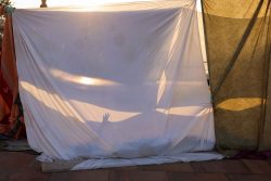 A resident rests in a makeshift shelter on a street next to a Gare Routiere, in the aftermath of a deadly earthquake, in Marrakech, Morocco, on Sept. 10.